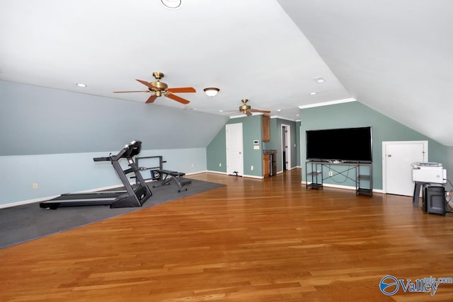 workout area with wood finished floors, ceiling fan, baseboards, and lofted ceiling