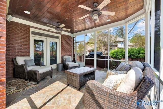 sunroom with an outdoor living space and a ceiling fan