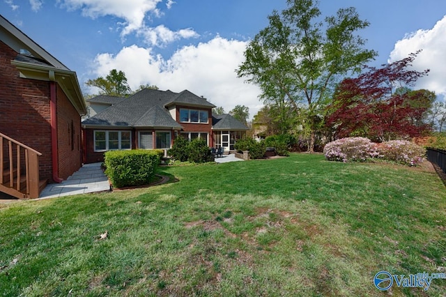 view of yard featuring fence and a patio