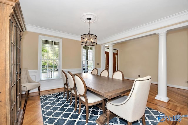 dining space with decorative columns, a notable chandelier, and ornamental molding