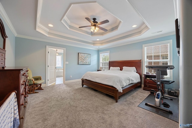 bedroom featuring crown molding, a tray ceiling, and light carpet