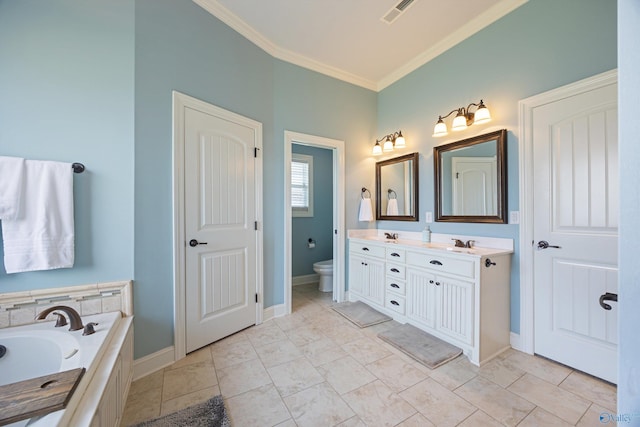 bathroom featuring vanity, ornamental molding, a bathing tub, and toilet