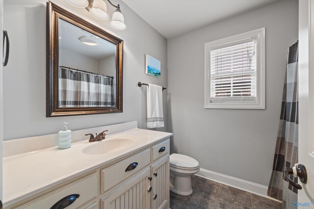 bathroom featuring vanity, tile patterned flooring, and toilet