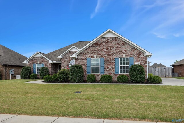 view of front of property with a front lawn and cooling unit