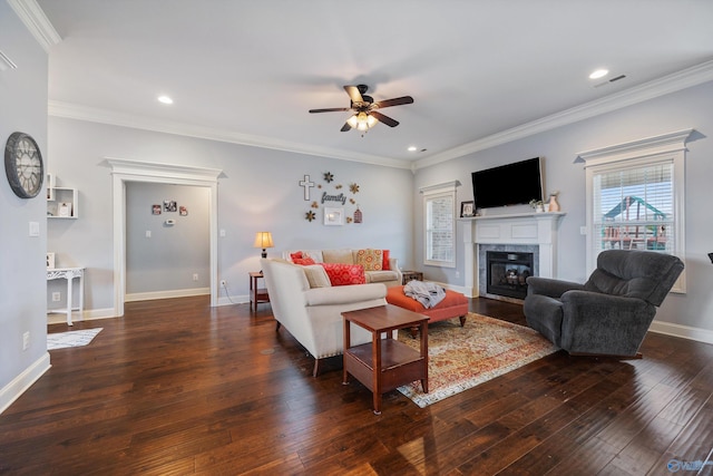 living room featuring crown molding, ceiling fan, a fireplace, and dark hardwood / wood-style flooring