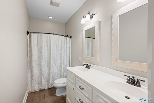 full bathroom featuring tile patterned floors, visible vents, double vanity, and a sink