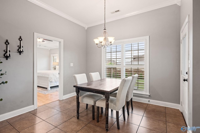 dining space featuring visible vents, baseboards, ornamental molding, tile patterned floors, and a notable chandelier