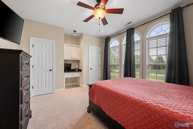 bedroom with baseboards, visible vents, light carpet, and ceiling fan