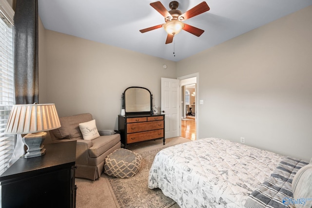 bedroom with ceiling fan and light colored carpet
