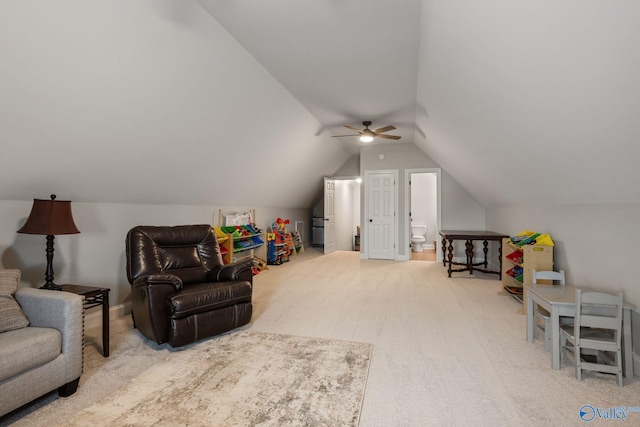 interior space featuring ceiling fan, vaulted ceiling, and carpet