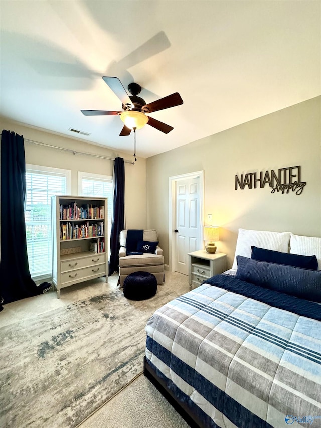 bedroom featuring visible vents, ceiling fan, and carpet