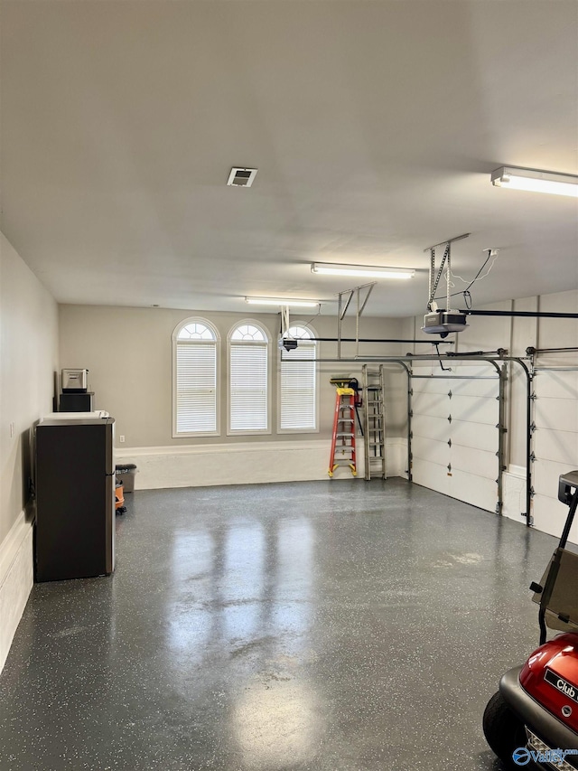 garage with visible vents and a garage door opener