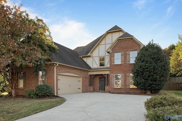 tudor house with a front yard and a garage