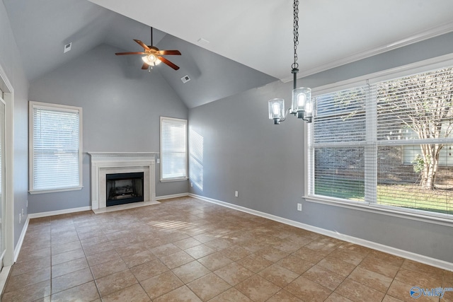 unfurnished living room with ceiling fan with notable chandelier, light tile patterned floors, and plenty of natural light