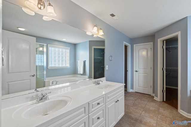 bathroom with vanity, plus walk in shower, and tile patterned floors