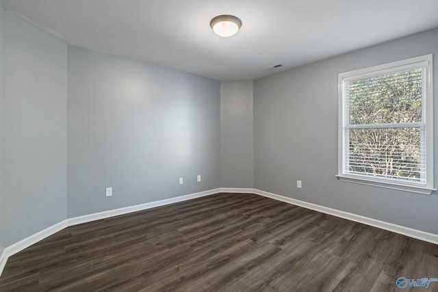 spare room with dark hardwood / wood-style flooring