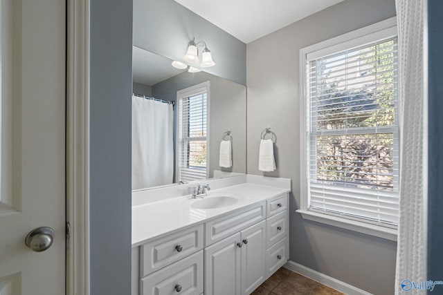 bathroom with vanity, curtained shower, a chandelier, and tile patterned floors