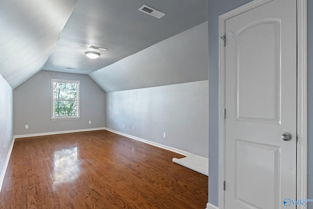 bonus room featuring vaulted ceiling and dark hardwood / wood-style flooring