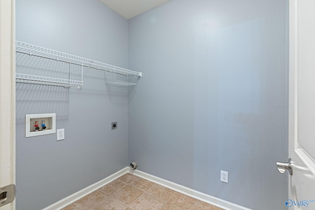 clothes washing area featuring hookup for an electric dryer, hookup for a washing machine, and light tile patterned floors