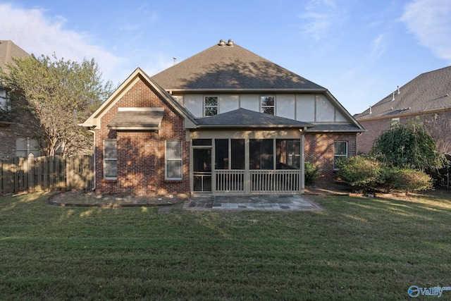 back of house with a yard and a sunroom