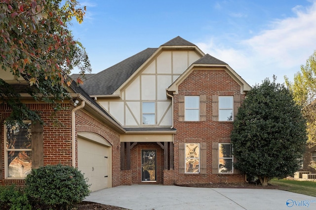 tudor house featuring a garage