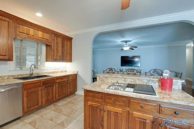 kitchen with arched walkways, brown cabinets, a sink, and stainless steel dishwasher