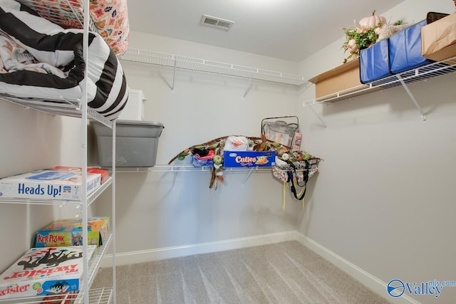 walk in closet with carpet floors and visible vents