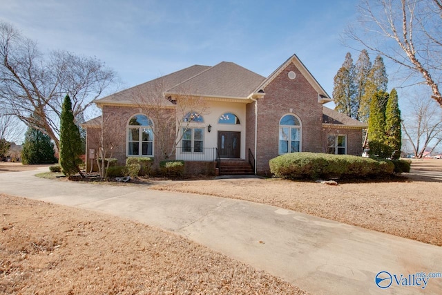 view of front facade with a porch and brick siding