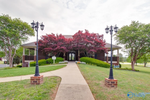 view of front of property with a porch and a front yard