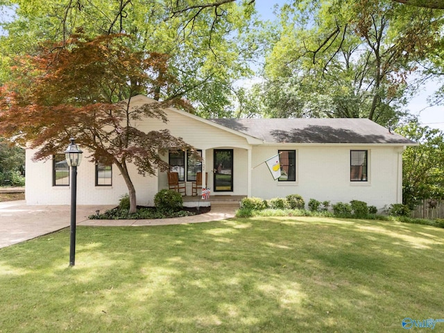 102 Robin Ln, Huntsville, AL 35802 - view of front of home featuring brick siding, covered porch, a front lawn, and a shingled roof