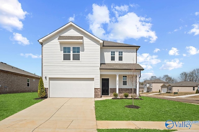 view of front of house featuring a garage and a front yard