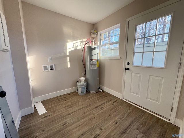 clothes washing area featuring hookup for a washing machine, hardwood / wood-style floors, and electric water heater