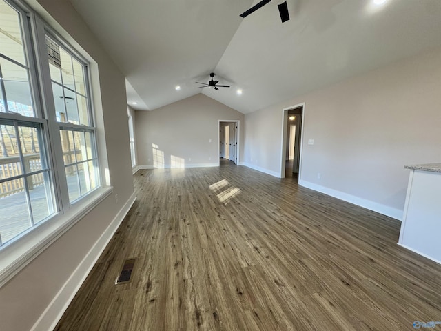 unfurnished living room featuring ceiling fan, dark hardwood / wood-style flooring, and lofted ceiling