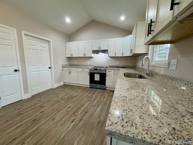 kitchen with stainless steel electric stove, vaulted ceiling, sink, white cabinets, and light stone countertops