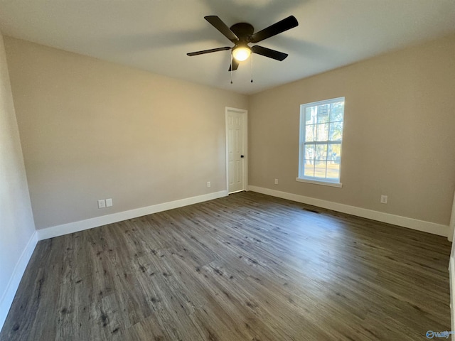 unfurnished room with ceiling fan and dark hardwood / wood-style flooring