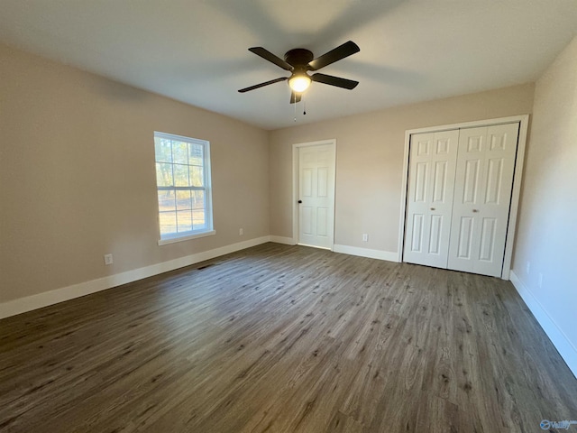 unfurnished bedroom with ceiling fan and dark hardwood / wood-style flooring