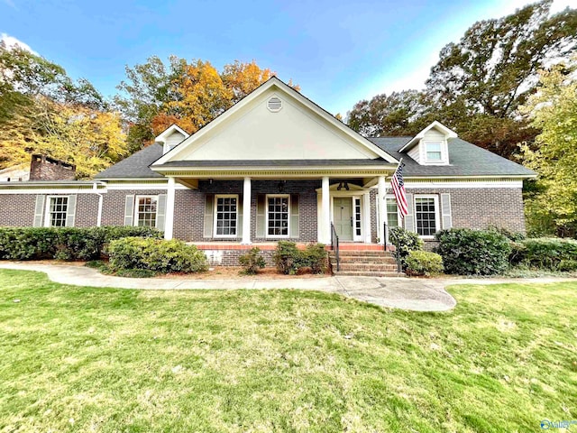 neoclassical home with covered porch and a front lawn