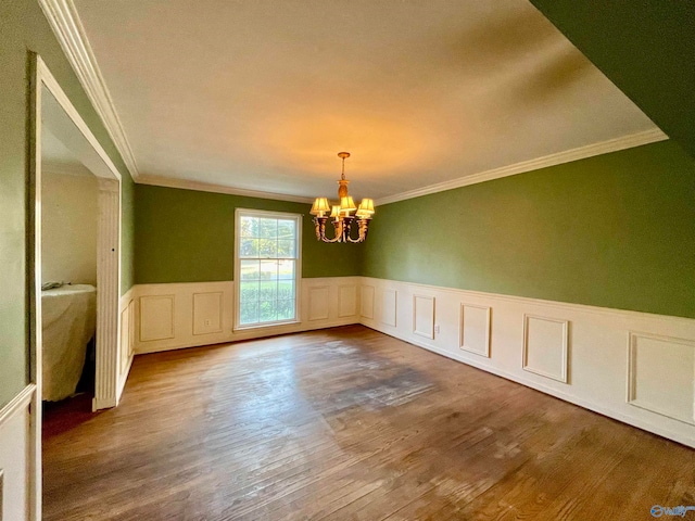 unfurnished dining area featuring a chandelier, wood-type flooring, and ornamental molding