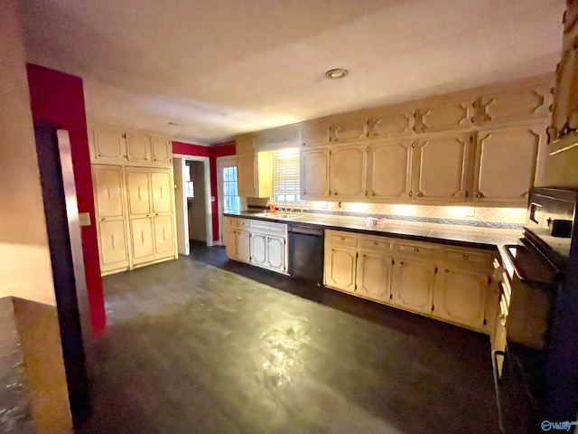 kitchen featuring backsplash, tile countertops, dishwasher, and sink