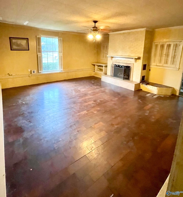 unfurnished living room with ceiling fan and a tile fireplace