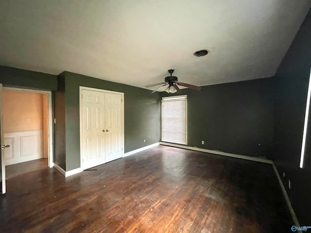 unfurnished bedroom with dark hardwood / wood-style flooring and ceiling fan