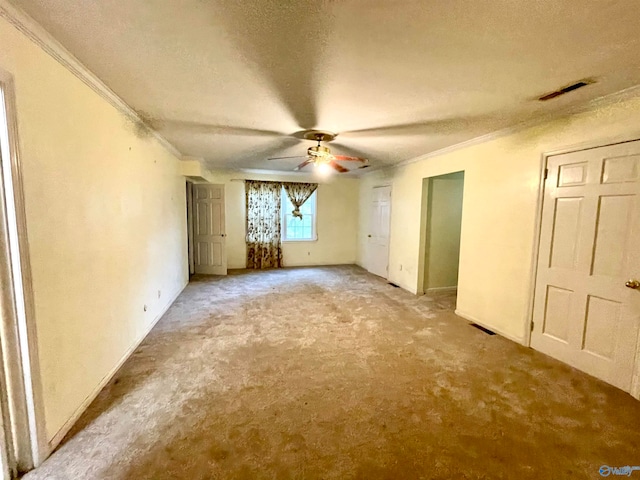 unfurnished bedroom featuring carpet flooring, a textured ceiling, and ornamental molding