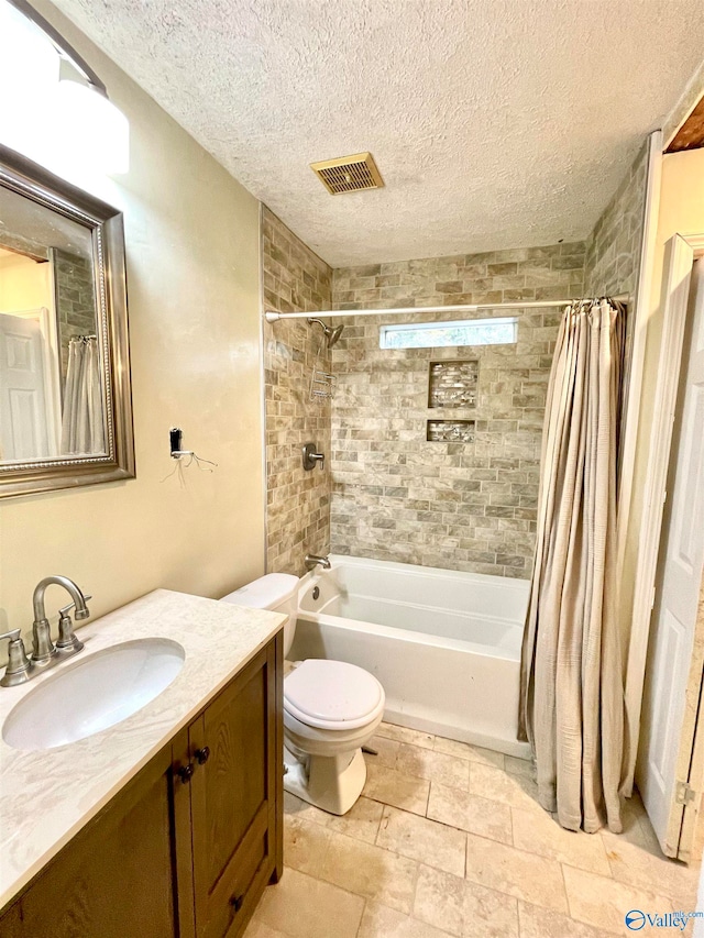 full bathroom with vanity, shower / bath combo, a textured ceiling, and toilet