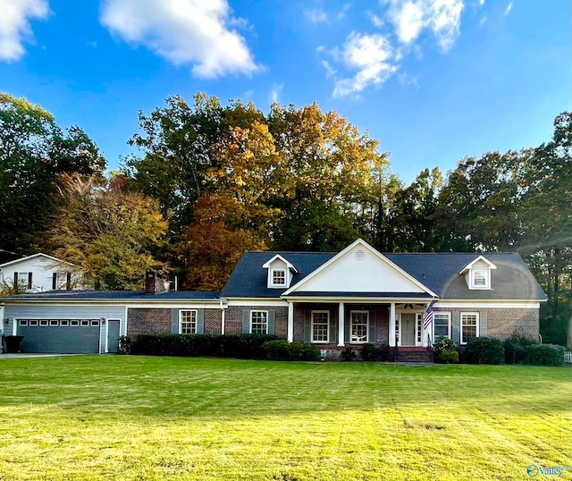 view of front of home with a garage and a front lawn