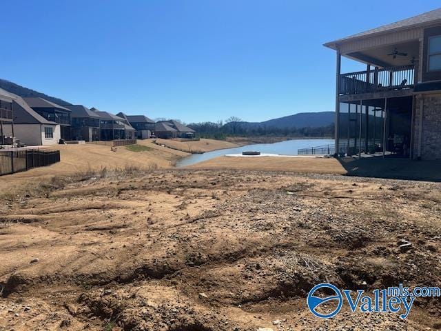 view of yard featuring a water view and a ceiling fan