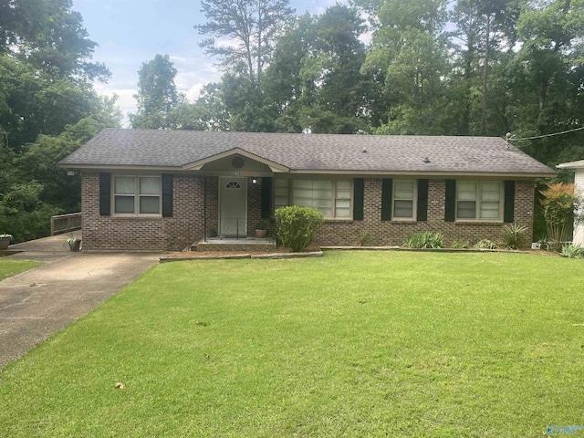216 Carol Ave, Gadsden, AL 35904 - ranch-style house featuring a front lawn, driveway, brick siding, and a shingled roof