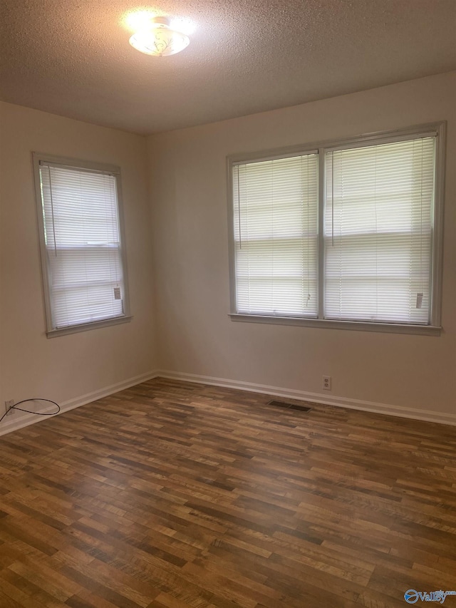 216 Carol Ave, Gadsden, AL 35904 - spare room with dark wood-type flooring, baseboards, and a textured ceiling