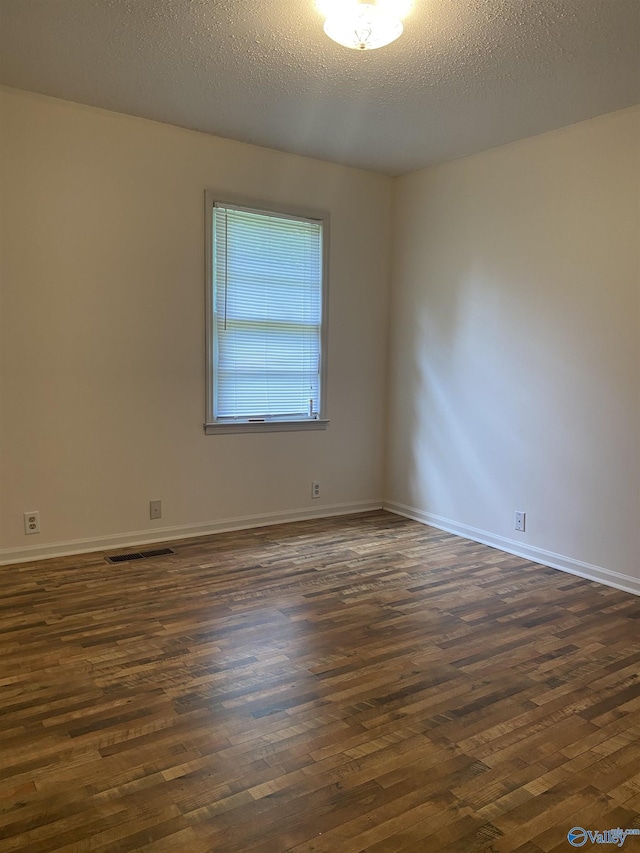 216 Carol Ave, Gadsden, AL 35904 - empty room featuring dark wood-style flooring, baseboards, and a textured ceiling