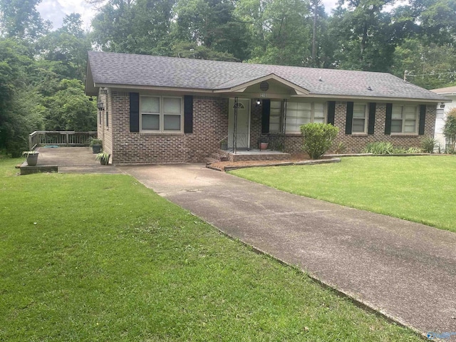 216 Carol Ave, Gadsden, AL 35904 - view of front of property featuring brick siding, a shingled roof, a front lawn, and driveway