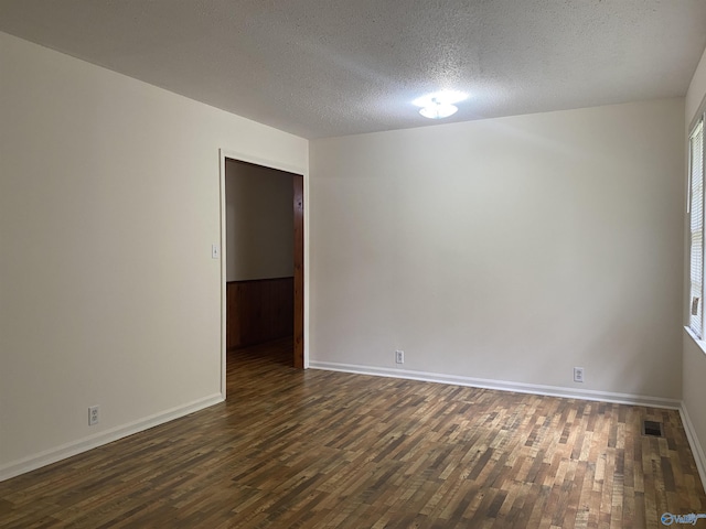 216 Carol Ave, Gadsden, AL 35904 - empty room featuring dark wood finished floors, a textured ceiling, and baseboards